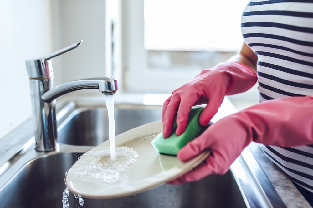 woman washing dishes with soft water